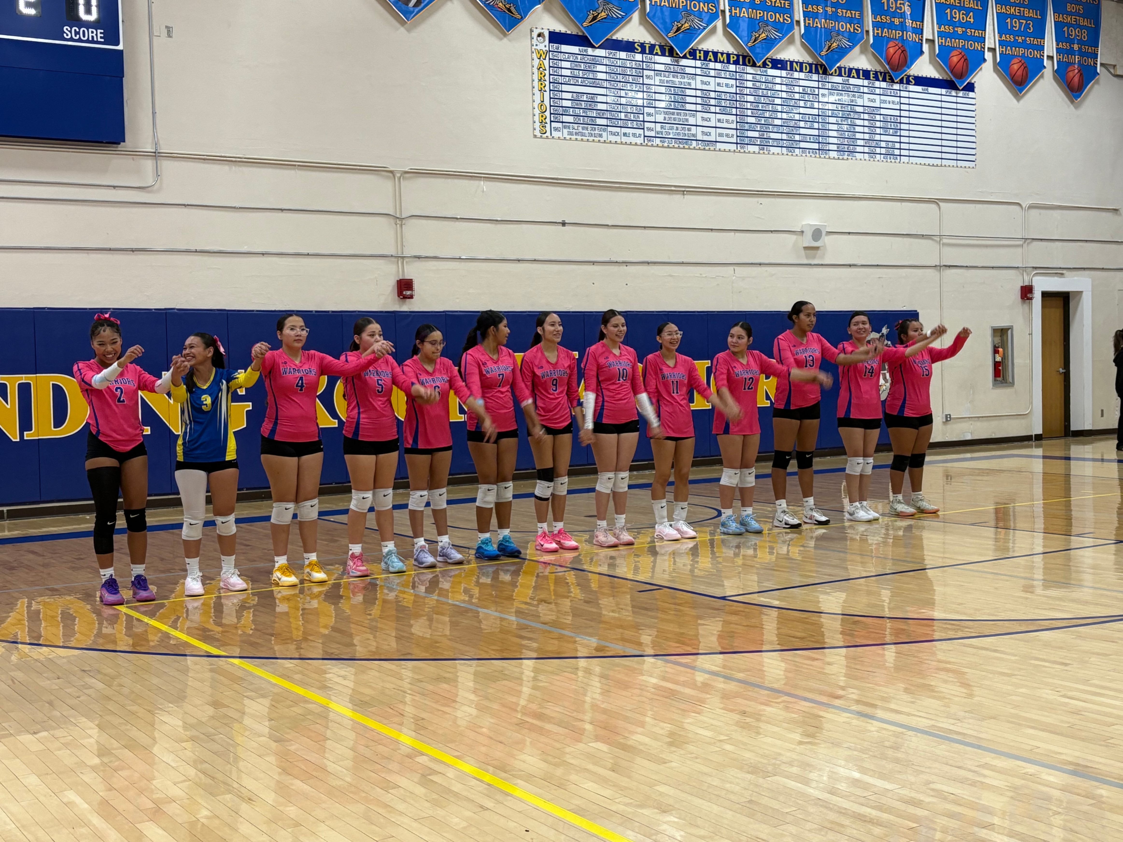 Lady Warriors Volleyball Senior Night wearing pink to support breast cancer awareness